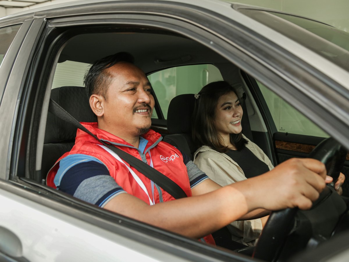 A couple smiling in their car